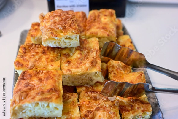 Fototapeta Bakery .Home made  cheese pie  with phyllo pastry, feta cheese  and organic eggs. Bulgarian banitsa. Brekfast on a display at Hotel