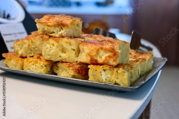 Fototapeta Bakery .Home made  cheese pie  with phyllo pastry, feta cheese  and organic eggs. Bulgarian banitsa. Brekfast on a display at Hotel