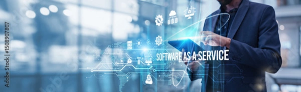 Fototapeta A businessman using a tablet analyzes Software as a Service (SaaS) and evaluates cloud-based subscription revenue growth metrics, customer acquisition trends, scalability potential, recurring revenue.