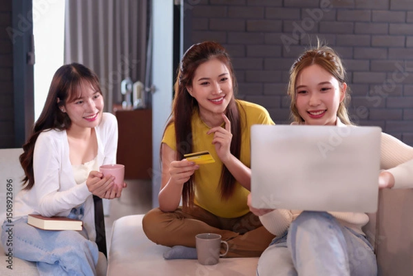Obraz Asian Women Shopping Online with Credit Card on Laptop Happy Friends Enjoying E-commerce Lifestyle at Home Online Banking Digital Payment Internet Purchasing