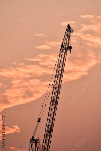 Fototapeta Crane truck working in construction site with sky background. Crane against sky. Crane, Construction background, construction equipment crane background.