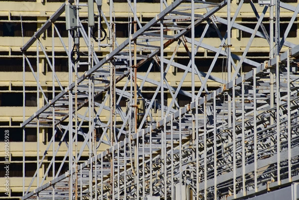 Fototapeta Metal scaffolding, used as temporary structure to support at the construction site. Construction concept. Construction equipment.