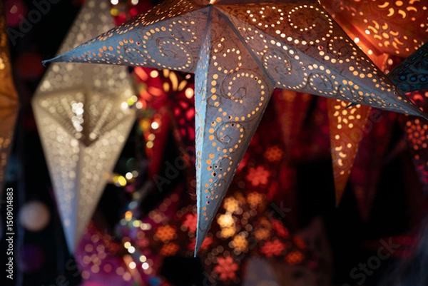 Fototapeta Close-up of colorful Christmas lanterns hanging at a Christmas market. The lanterns are lit from the inside.