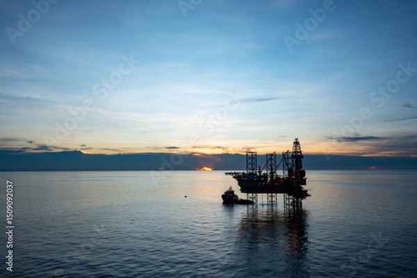 Obraz Aerial view of offshore jack up drilling rig during sunset - oil and gas industry.