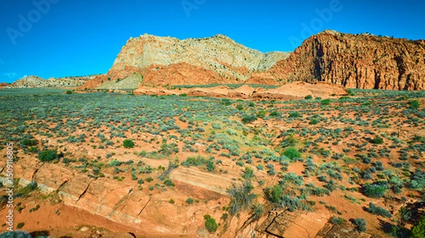Fototapeta Aerial Fly Over Red Sandstone Cliffs Desert Plain and Rocky Strata in Utah