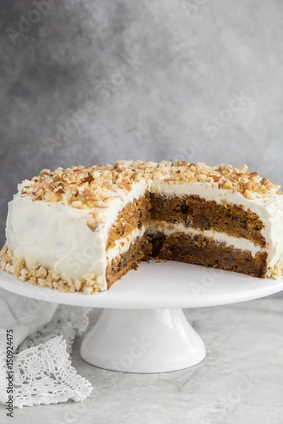 Fototapeta homemade carrot cake with cream cheese frosting and nuts