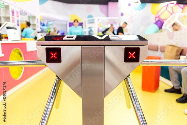 Fototapeta Closed two-way tripod turnstile in front of the entrance.