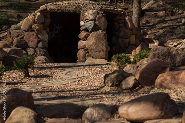 Obraz the cave or dugout is made of stones in the park