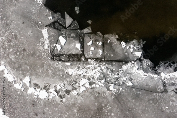 Obraz The texture of a frozen lake and pieces of floating ice in the water. Winter landscape from a drone.