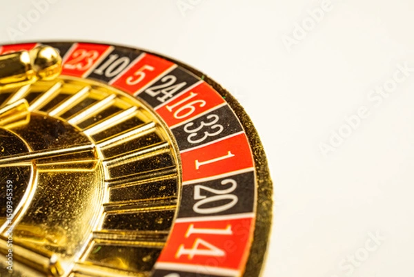 Fototapeta Close-up view of a golden, shiny slot machine with spinning reels