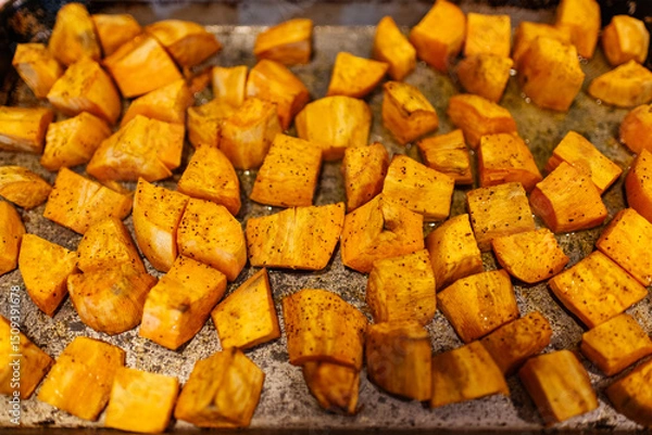 Obraz Fried Sweet Potatoes in a pan with seasoning 