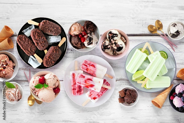Obraz Cool summer food table scene. Variety of ice cream bowls, popsicles and frozen treats. Above view on a white wood background.