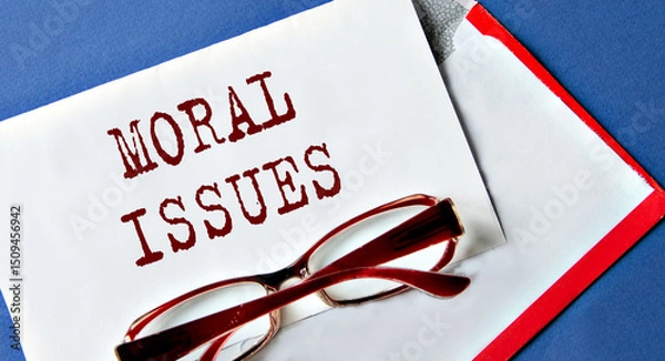 Fototapeta MORAL ISSUES - words on a white sheet with an envelope and glasses on the background