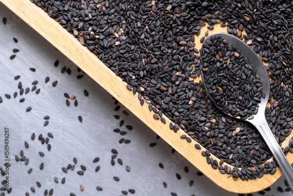 Obraz Black sesame seed in spoon and wooden plate, Healthy eating, Top view