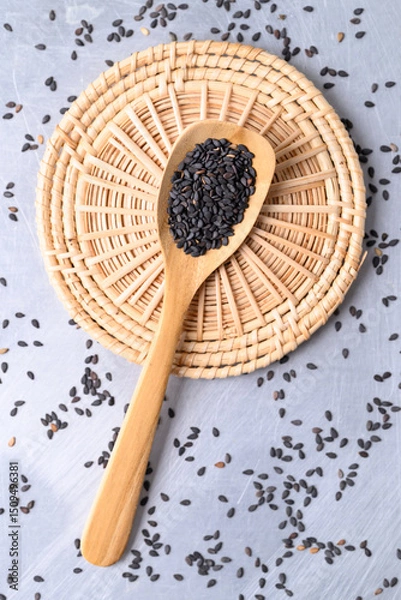 Obraz Black sesame seed in wooden spoon, Food ingredient, Top view