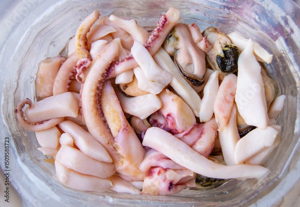 Fototapeta Top view of seafood, ready to eat tentacles and squid, food background