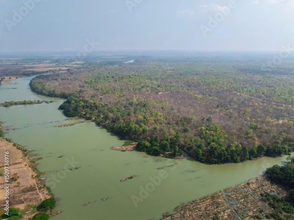 Fototapeta Lush greenery and winding river in Buon Don district, Dak Lak province, Vietnam during daytime