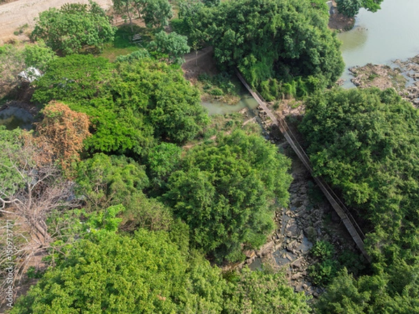 Fototapeta Exploring lush greenery and a rustic bridge in Buon Don district, Dak Lak province, Vietnam during a sunny afternoon