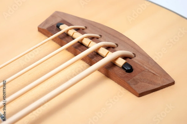 Obraz Four-string bass ukulele with wooden body and built-in tuner and pickup.