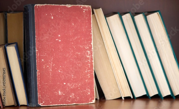Fototapeta Old book with copy space on a bookshelf. Home library