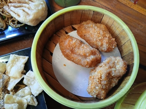Fototapeta Chicken croquettes with cheese filling inside served in a round bowl made of yellow bamboo