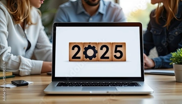 Fototapeta Wooden calendar blocks showing year 2025 on laptop screen