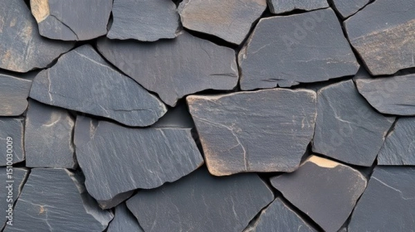 Fototapeta Textured Slate Mosaic: A detailed, close-up shot showcases the beauty of a natural slate mosaic wall, its irregular, gray stones fitting together to create a pattern.