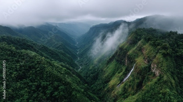 Obraz Dramatic aerial view of a hidden jungle canyon revealing steep green walls and cascading waterfalls in a tropical rainforest