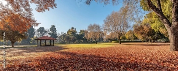 Obraz picturesque autumn park with leaves in shades of red and gold, scattered on the ground beneath vibrant trees, Generative AI