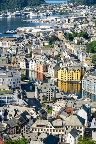 Fototapeta View of downtown of Alesund in Norway, with its colorful Art Nouveau buildings along the brosundet Canal and the sea in background in a sunny day