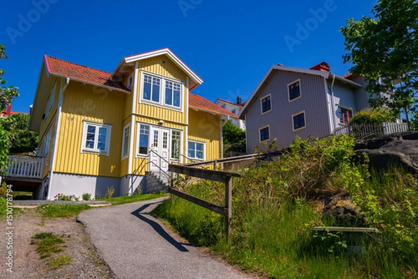 Obraz Picturesque colony of old small wooden historic houses on the Slottsberget mountain on the banks of the Gota alv river, Gothenburg, Sweden, sunny day