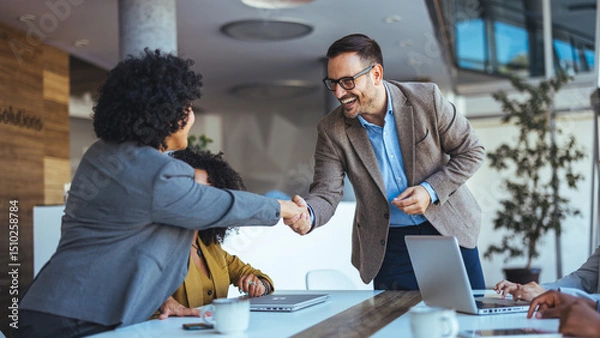 Fototapeta Professionals Greeting Each Other During a Productive Business Meeting in a Modern Office