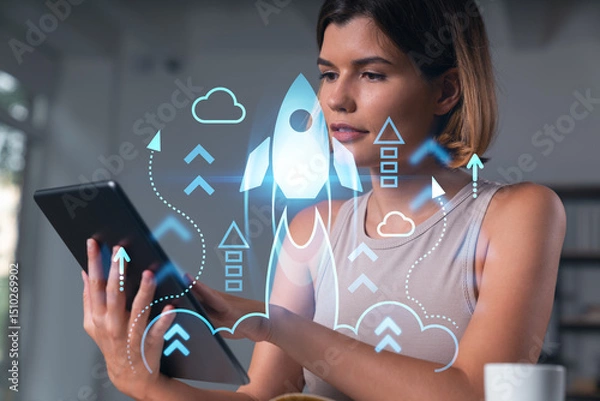 Fototapeta Smiling businesswoman in casual wear holding tablet device touching it at office workplace. Concept of distant work, business education, information technology. Start up hologram