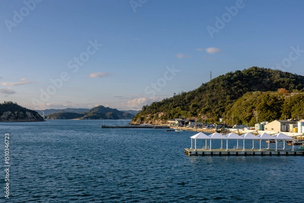 Fototapeta Ferry Approaching Naoshima Island during Tranquil Evening Light, Setouchi, Japan