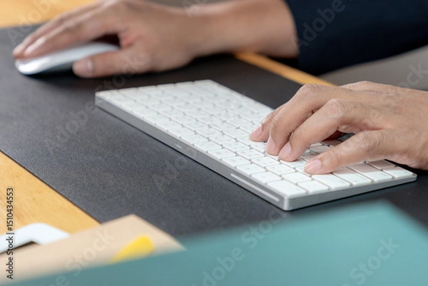 Fototapeta Hands typing on a keyboard — concept of office work, productivity, and digital communication