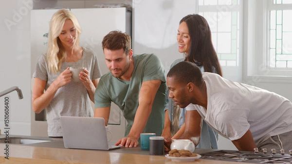 Obraz Group Of Multi Cultural Friends Looking At Laptop And Drinking Coffee In Modern Kitchen