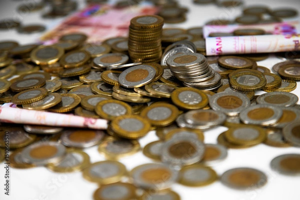 Obraz Close up of a lot of Ghanaian cedi coins with few notes spread on desk