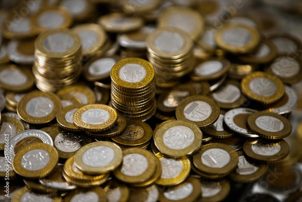 Obraz Close up of a lot of Ghanaian cedi coins with few notes spread on desk