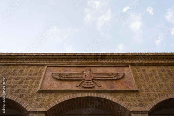 Fototapeta Zoroastrian fire temple in Yazd, Iran, featuring the iconic Faravahar symbol, intricate masonry, and rich Persian heritage under a clear sky.