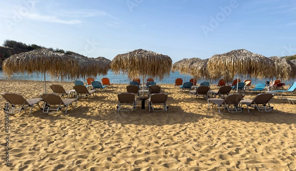 Obraz Straw umbrellas and beach chairs on sand, Sunny day at sea. Summer holidays