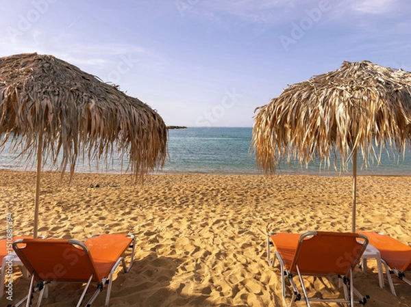 Obraz Straw umbrellas and sunbeds on sandy beach, Sunny day at sea. Summer holidays