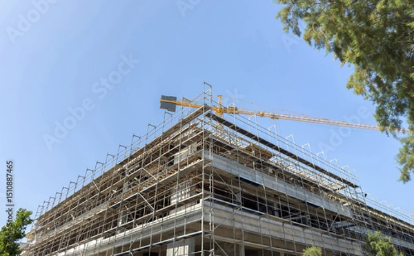 Obraz Building construction site, scaffolding system and tower crane, under construction project