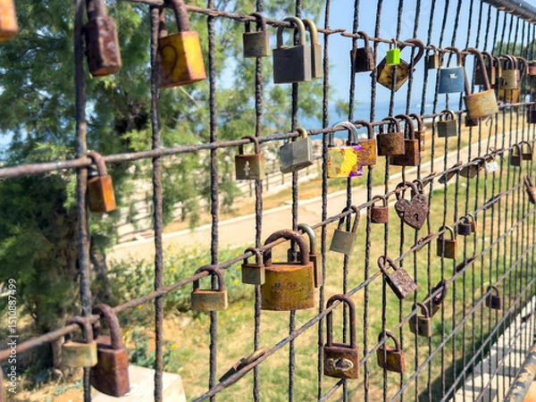 Obraz Love lock. Rusty padlocks on metal fence grid, closeup. Love and commitment concept