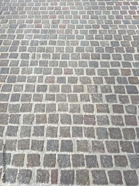 Fototapeta Stone paved floor background texture. Cobblestone grey footpath above view