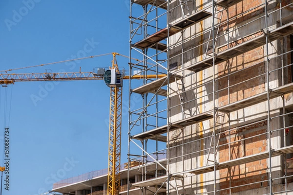 Obraz Building construction site, scaffolding system and tower crane, under construction project