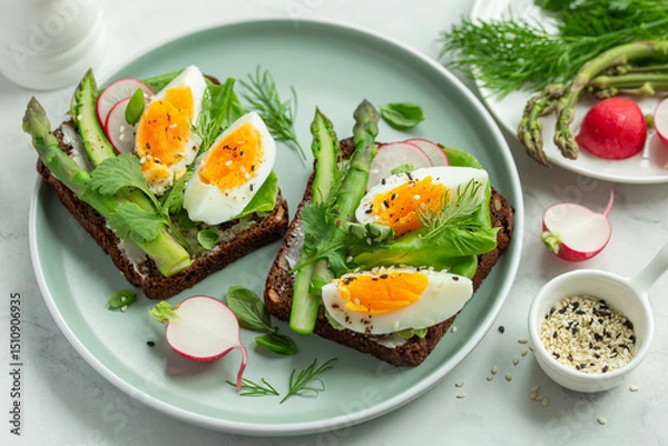 Fototapeta  sandwich with dark rye bread, asparagus and  egg