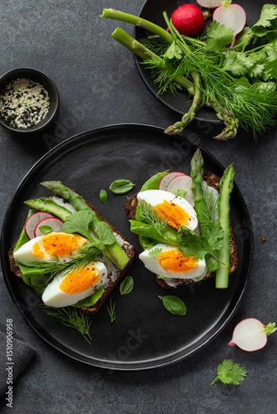 Fototapeta sandwich with dark rye bread asparagus and soft boiled egg