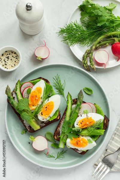 Fototapeta sandwich with dark rye bread, asparagus and soft boiled egg
