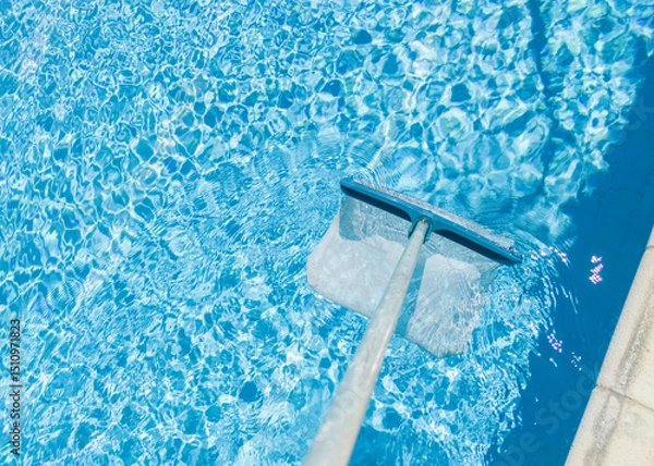 Fototapeta Cleaning surface of pool with scoop net