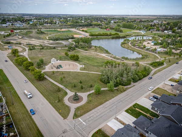 Fototapeta Park with a pond and a playground